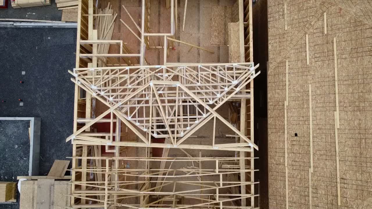 Aerial view of wooden roof trusses on a house under construction